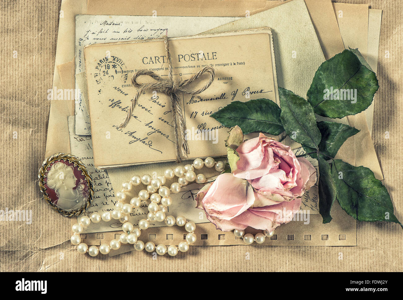 Old letters, postcards and vintage accessories. Paper background with dry rose flower. Retro style toned picture Stock Photo