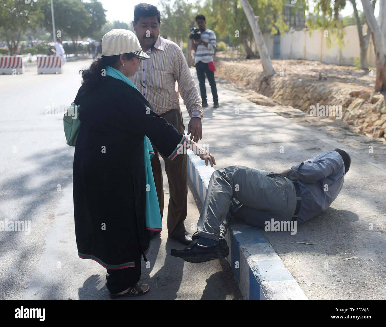 Woman protester consoling injured employee of Pakistan International Airlines who tortured by security forces during demonstration against privatization, near Jinnah International Airport in Karachi on Tuesday, February 02, 2016. Stock Photo