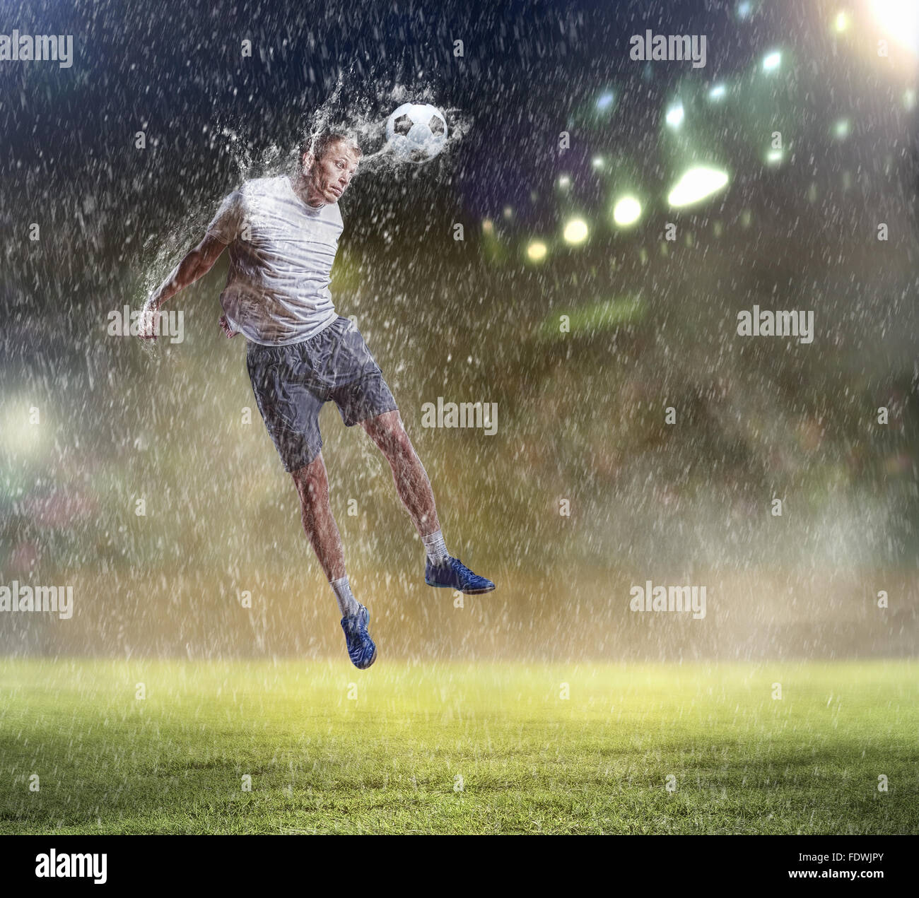 football player in white shirt striking the ball with head at the ...