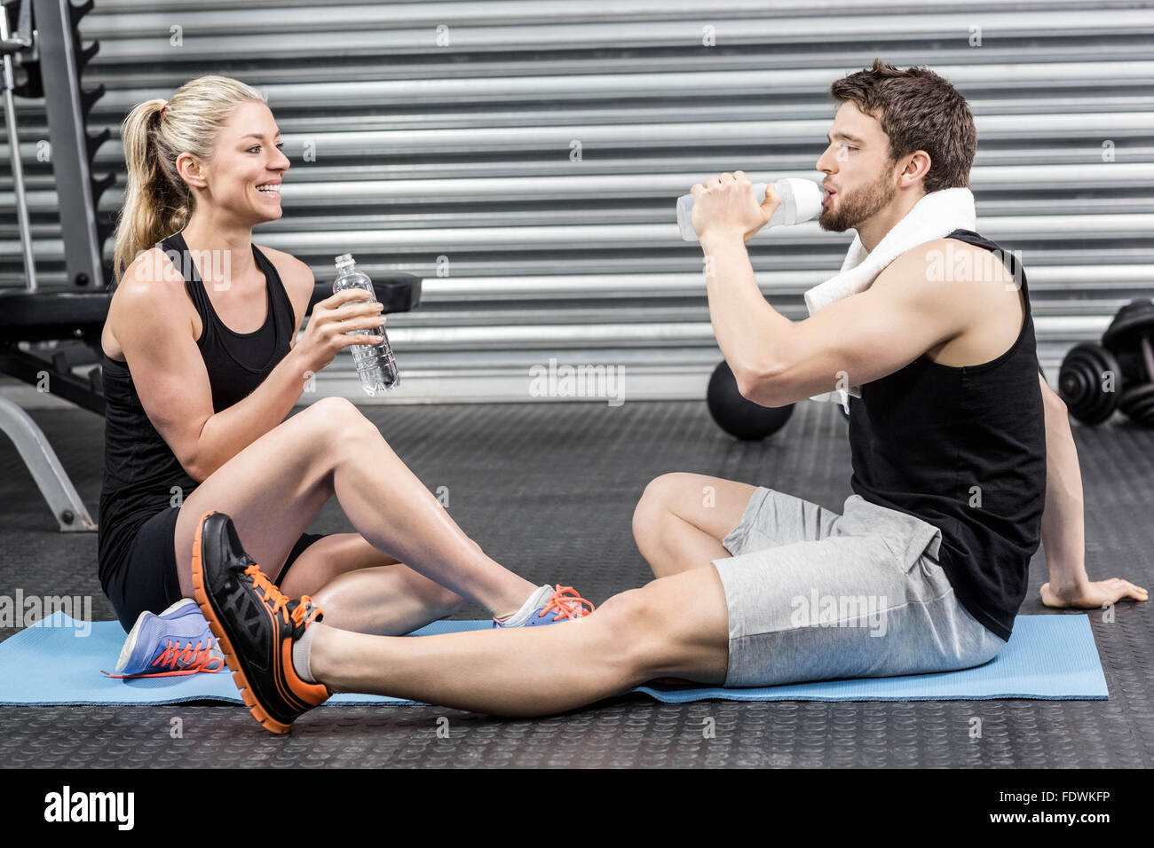 Couple sitting on fitness mat Stock Photo