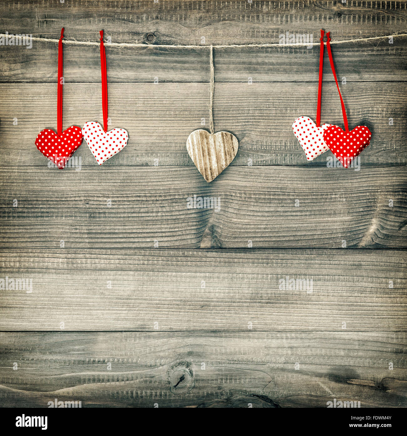 Red hearts hanging on clothesline over wooden background. Valentines ...