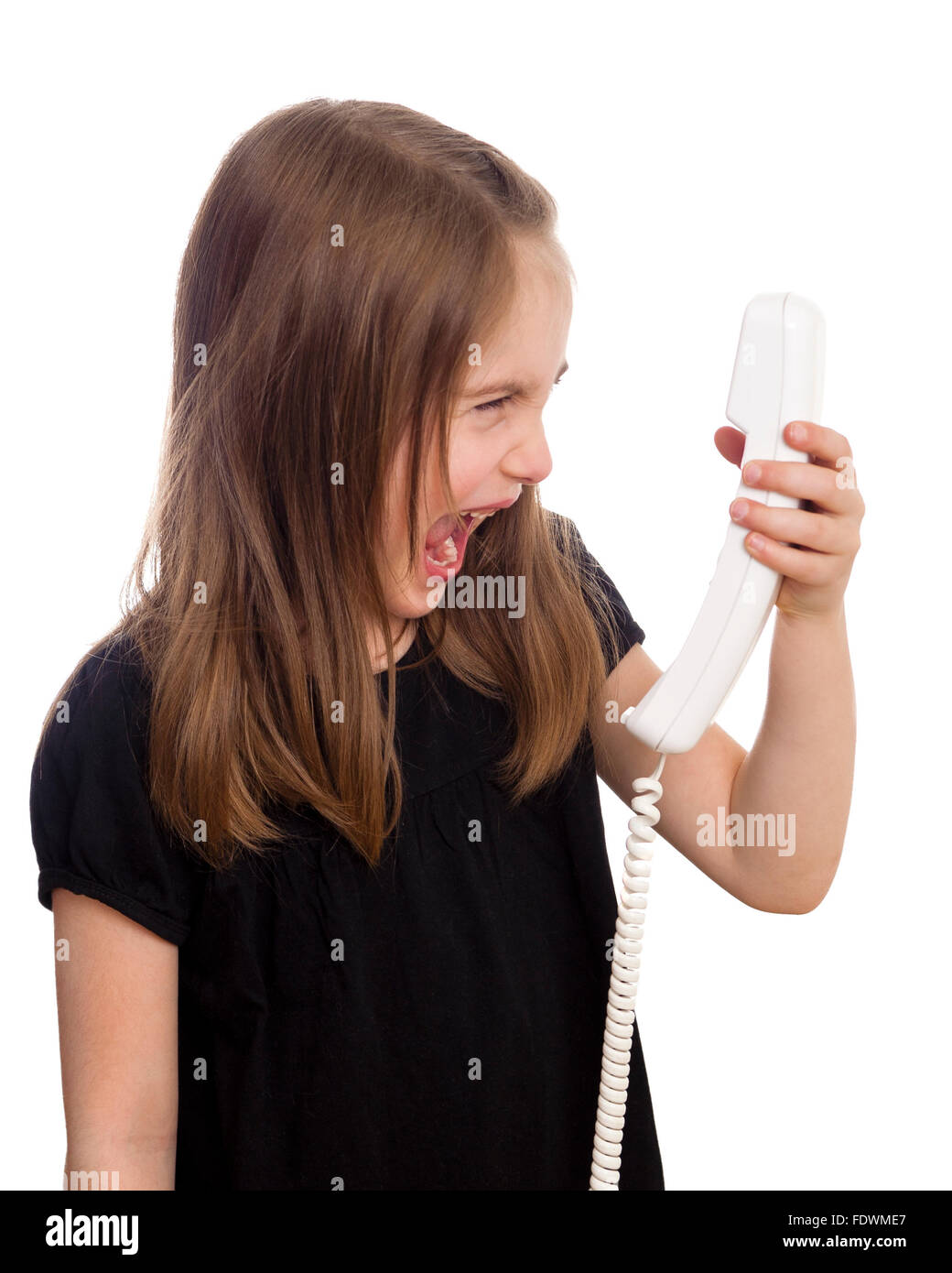 Young girl shouting at the phone isolated on white background  Model Release: Yes.  Property release: No. Stock Photo