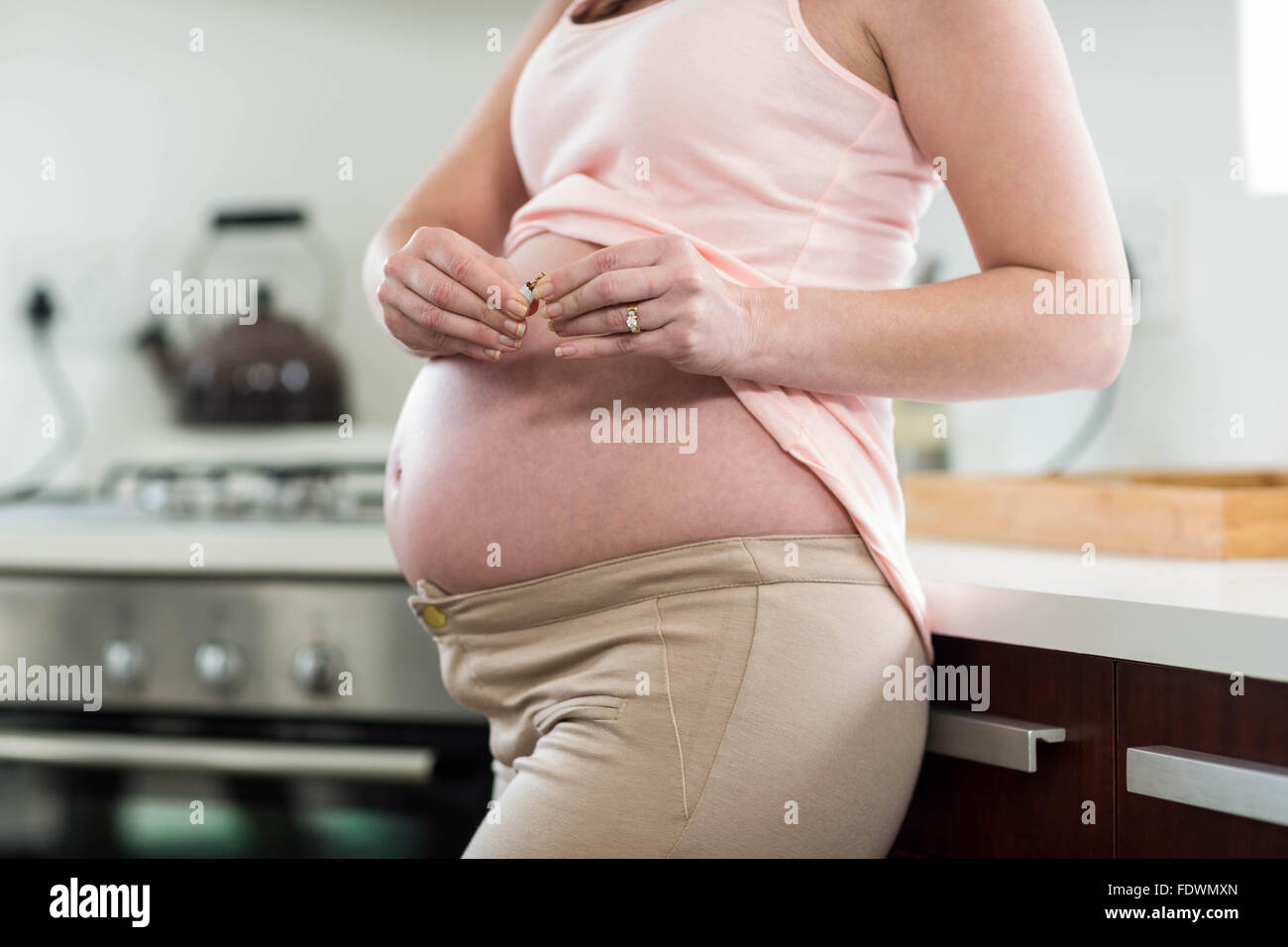 Pregnant woman destroying cigarette Stock Photo