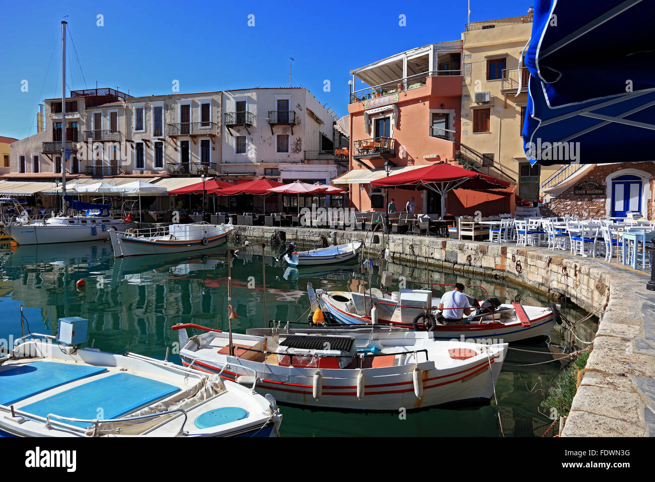 Crete, port Rethymno, boats in the Venetian harbour, street restaurants along the promenade Stock Photo