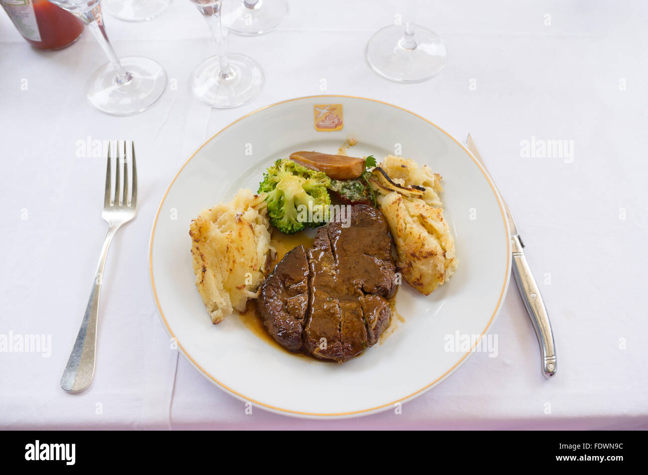 Steak and potatoes au gratin dinner at La Colombe d'Or in Saint Paul de Vence, France  Model Release: No.  Property Release: No. Stock Photo