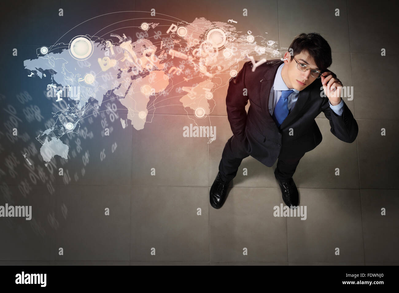 Top view of young businessman making decision against global network back Stock Photo