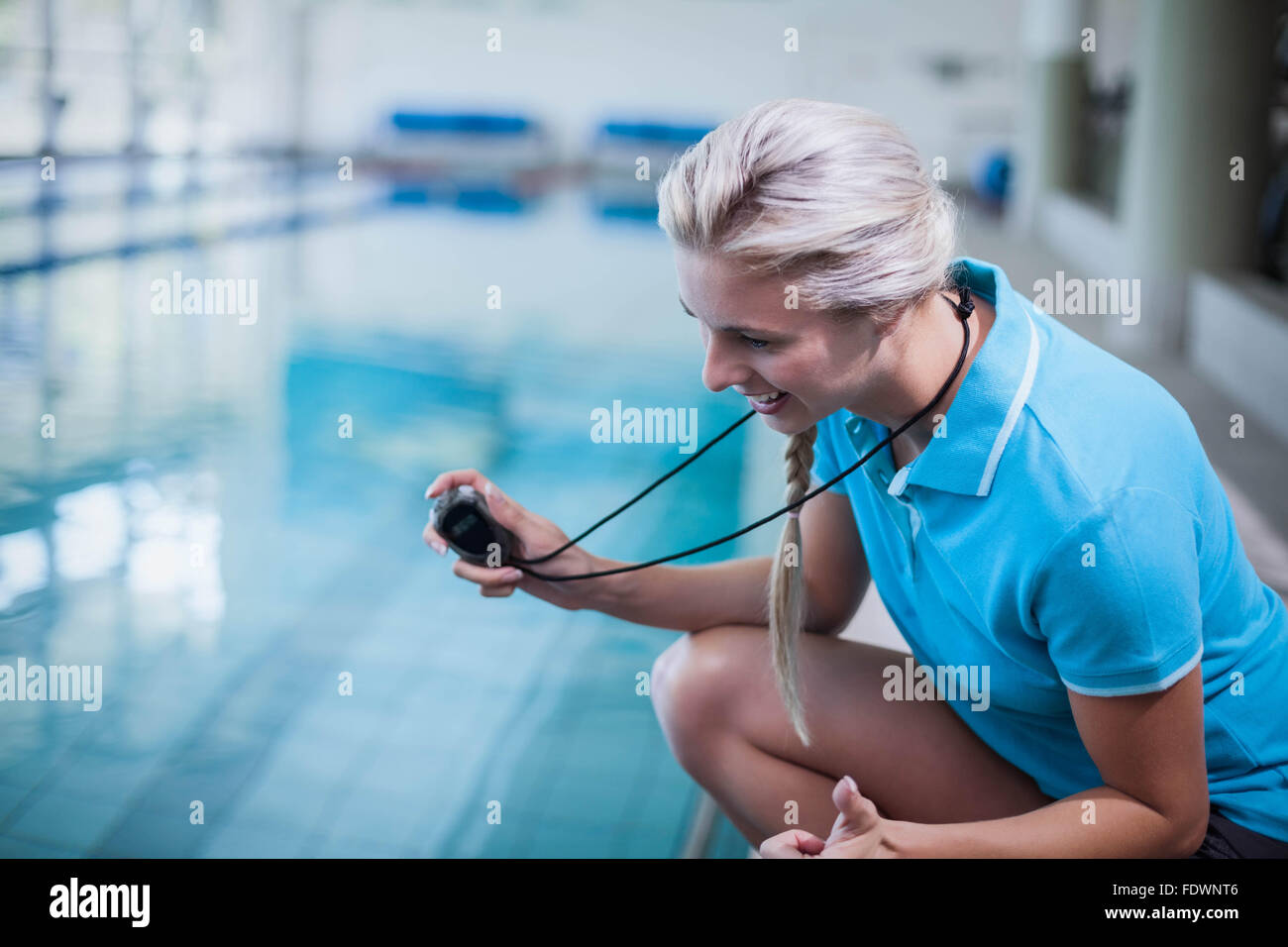 Fit trainer showing stopwatch Stock Photo Alamy