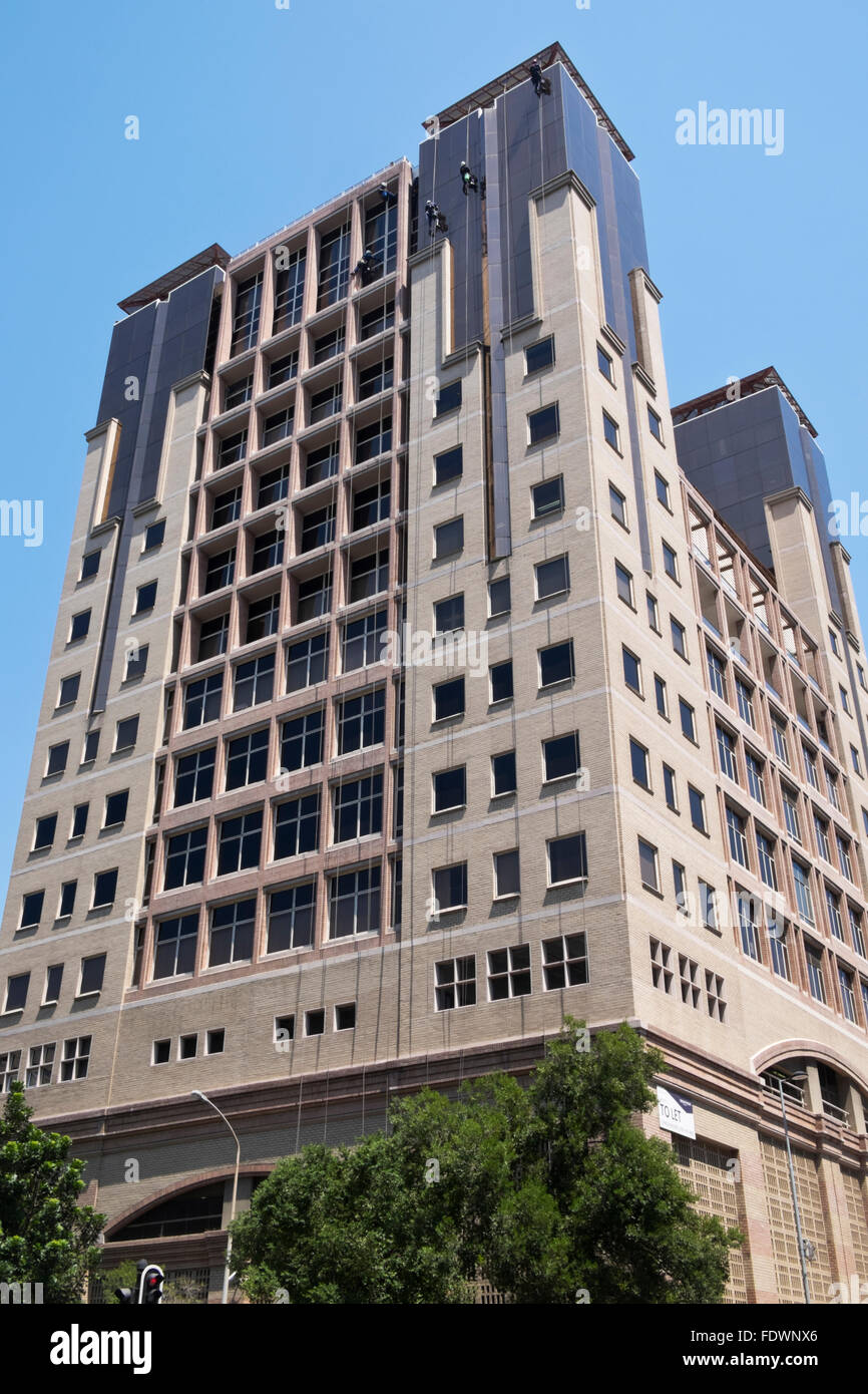 Window washers cleaning the windows of a high rise office block in Cape