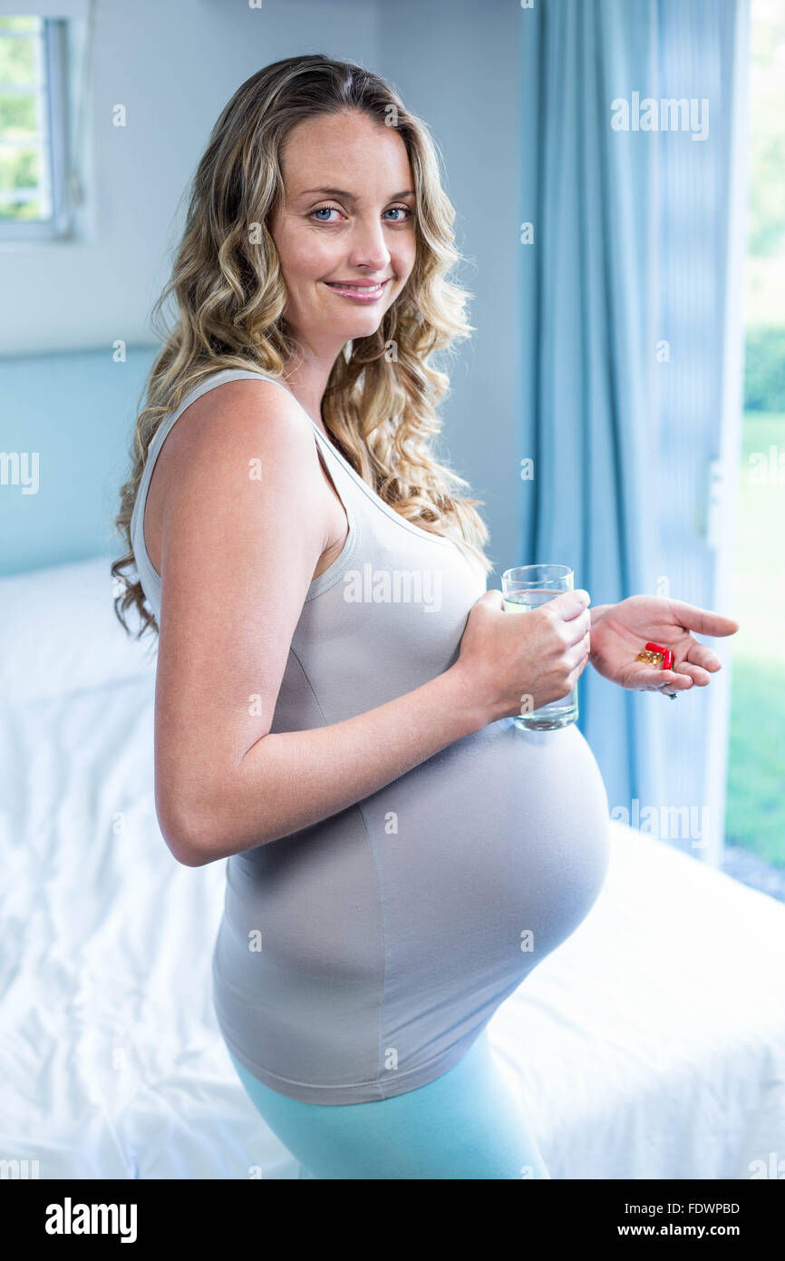 Pregnant woman taking a pill Stock Photo Alamy