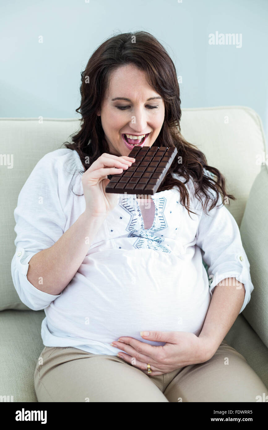 Pregnant woman eating chocolate Stock Photo Alamy