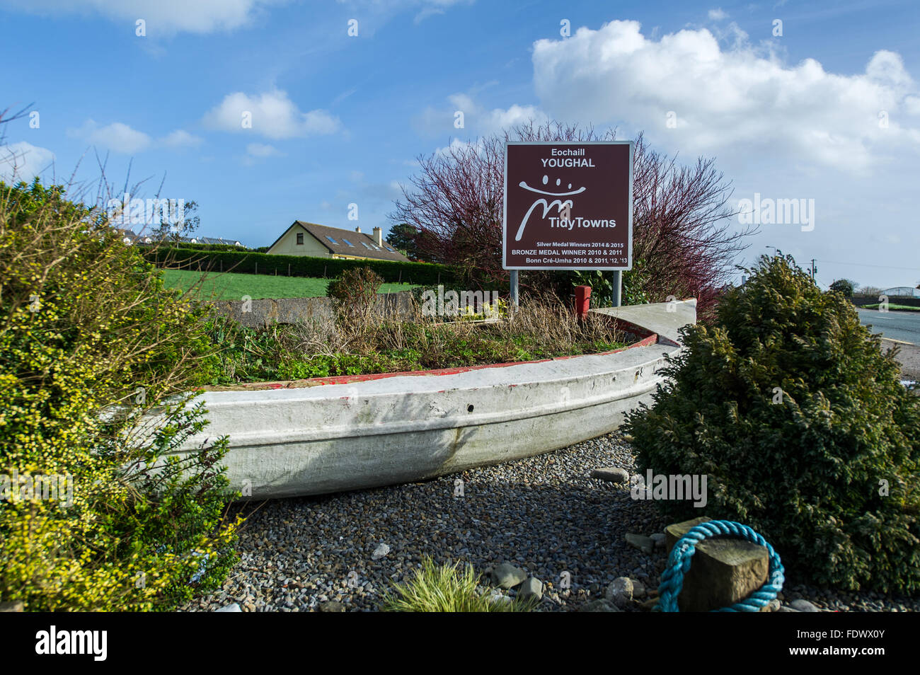 Youghal Tidy Towns sign with a boat full of flowers and plants, just outside Youghal, Co Cork, Ireland Stock Photo