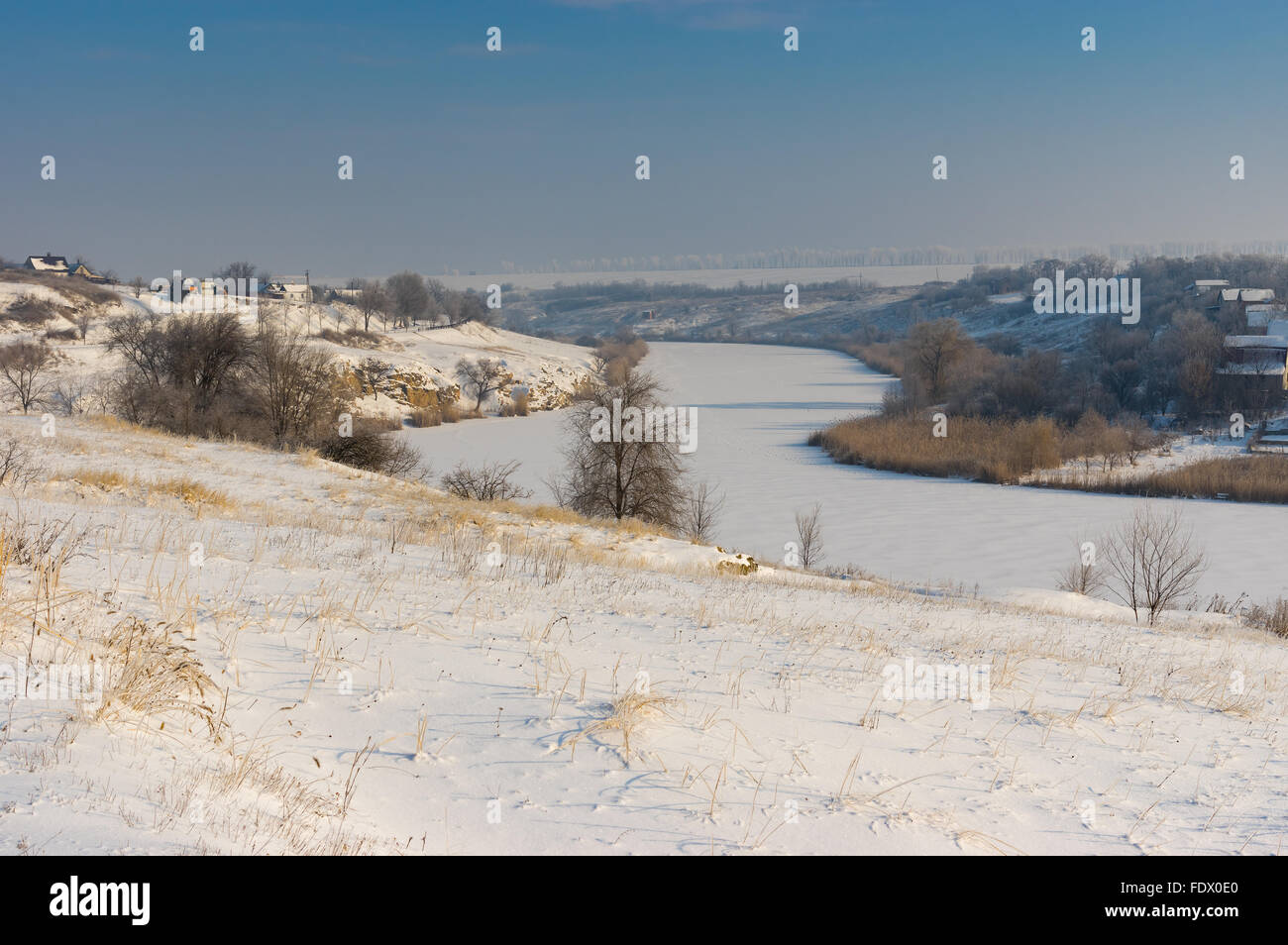Winter landscape with Small river Sura flowing through Novo-Nikolaevka village in Dnepropetrovskaya oblast, Ukraine Stock Photo