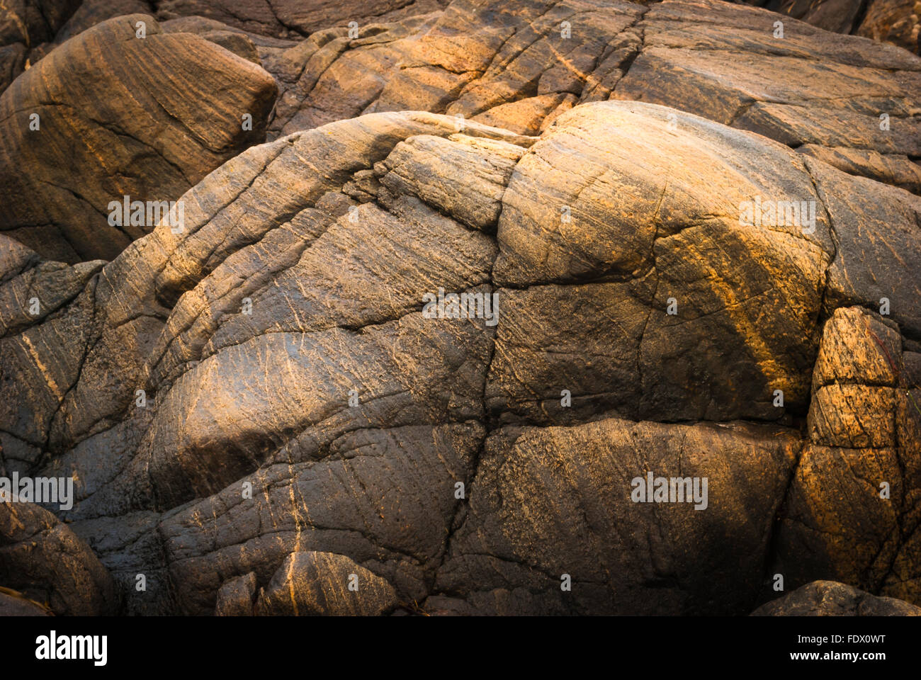 Light coloured rock running through dark  bed rock Stock Photo