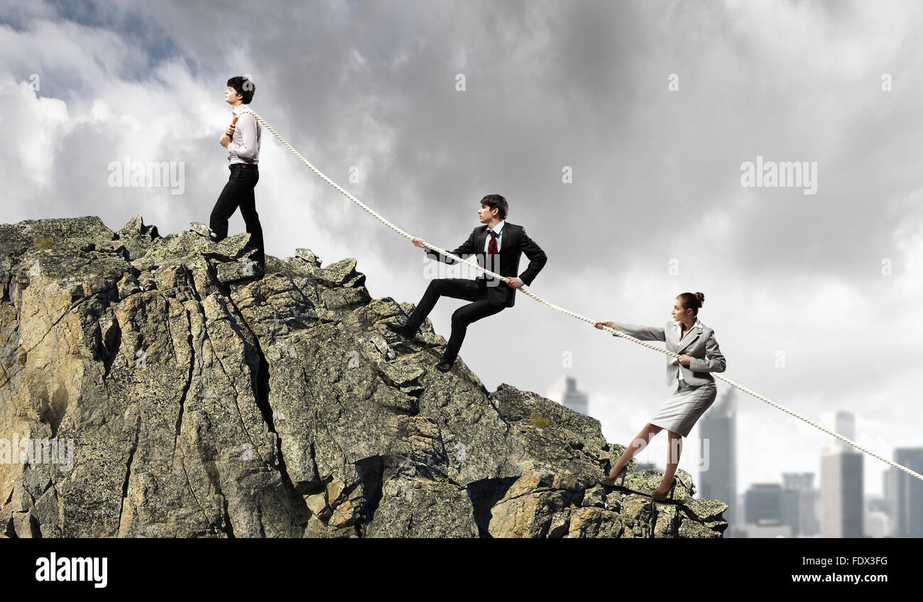 Wiking Over Rope Image of three businesspeople pulling rope atop of mountain Stock Photo ...