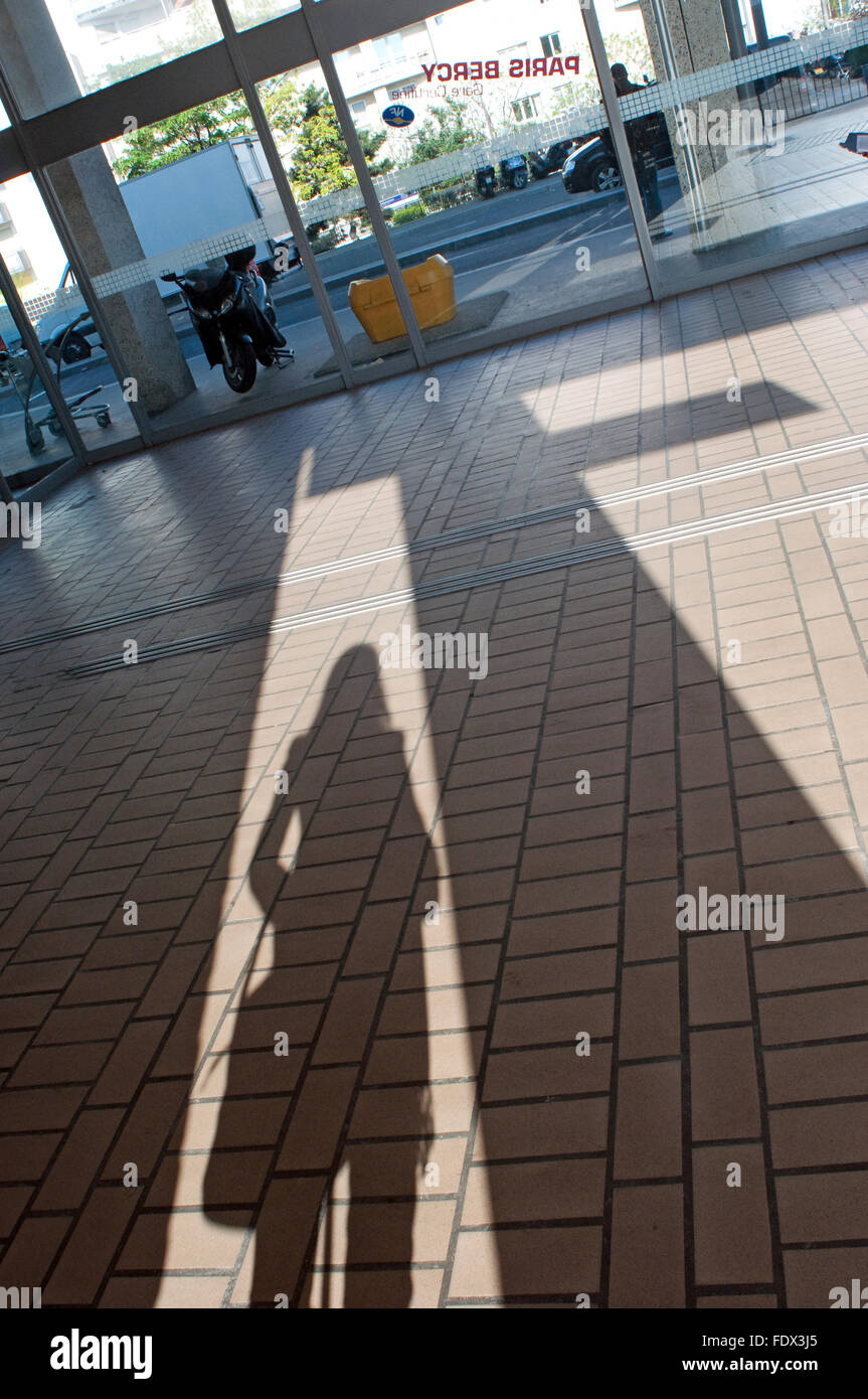 Shadow Silhouette of a woman traveler at Gare de Paris Bercy France Railway Station SNCF Stock Photo