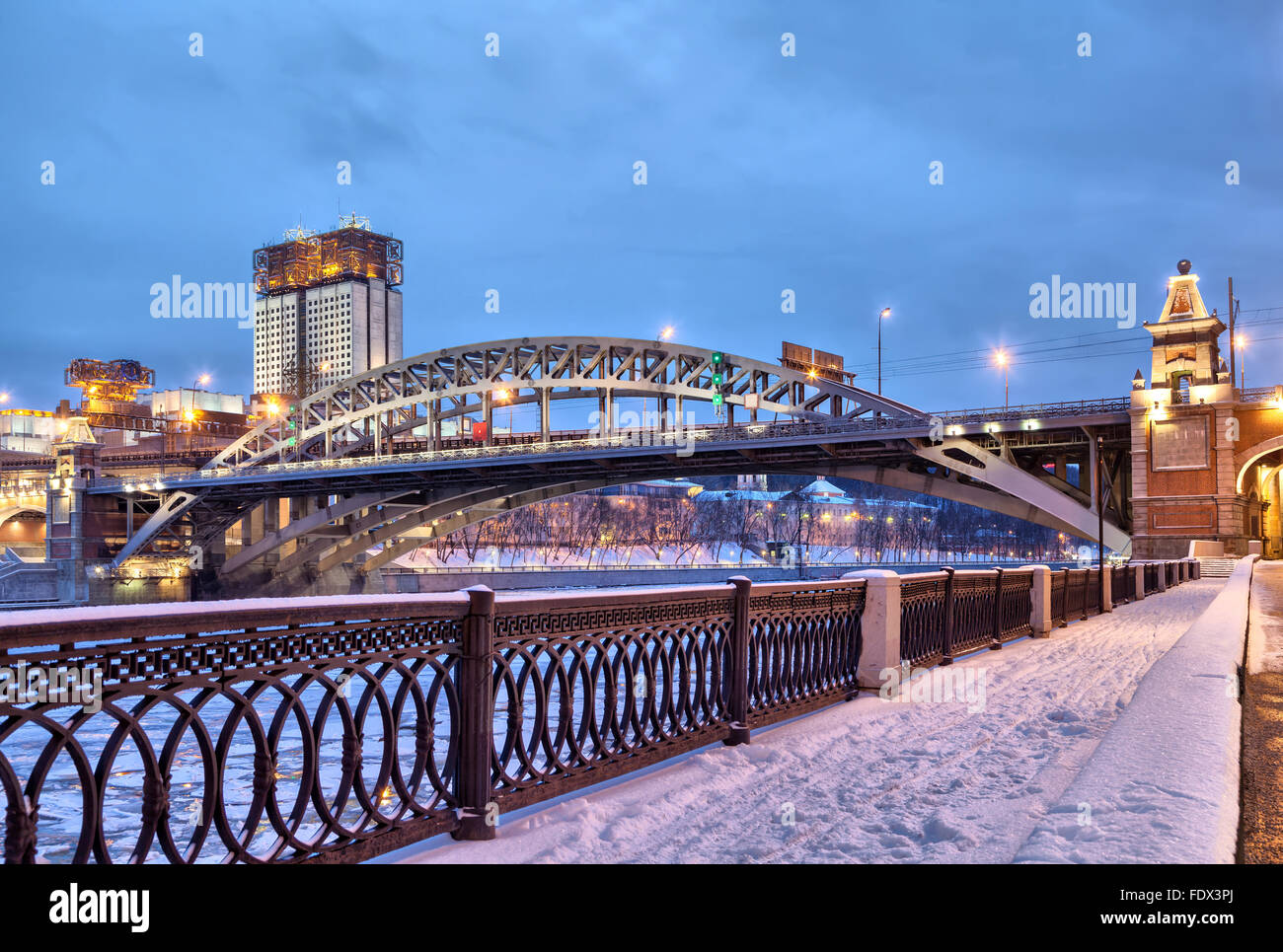 Embankment of Moscow river near Andreevsky railroad bridge and building of Science Academy in the evening, Moscow, Russia Stock Photo