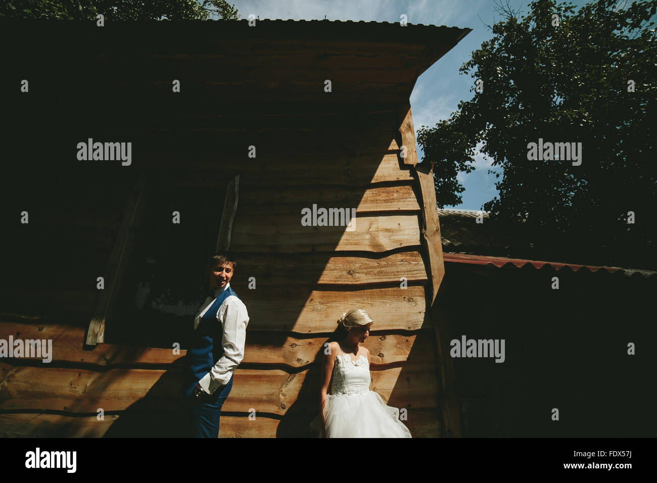beautiful young wedding couple stands near house Stock Photo Alamy