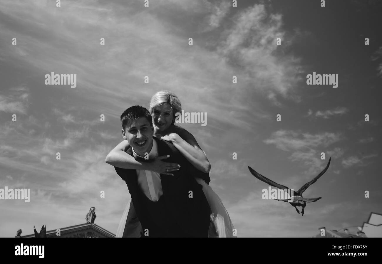 bride and groom on the background of sky Stock Photo - Alamy
