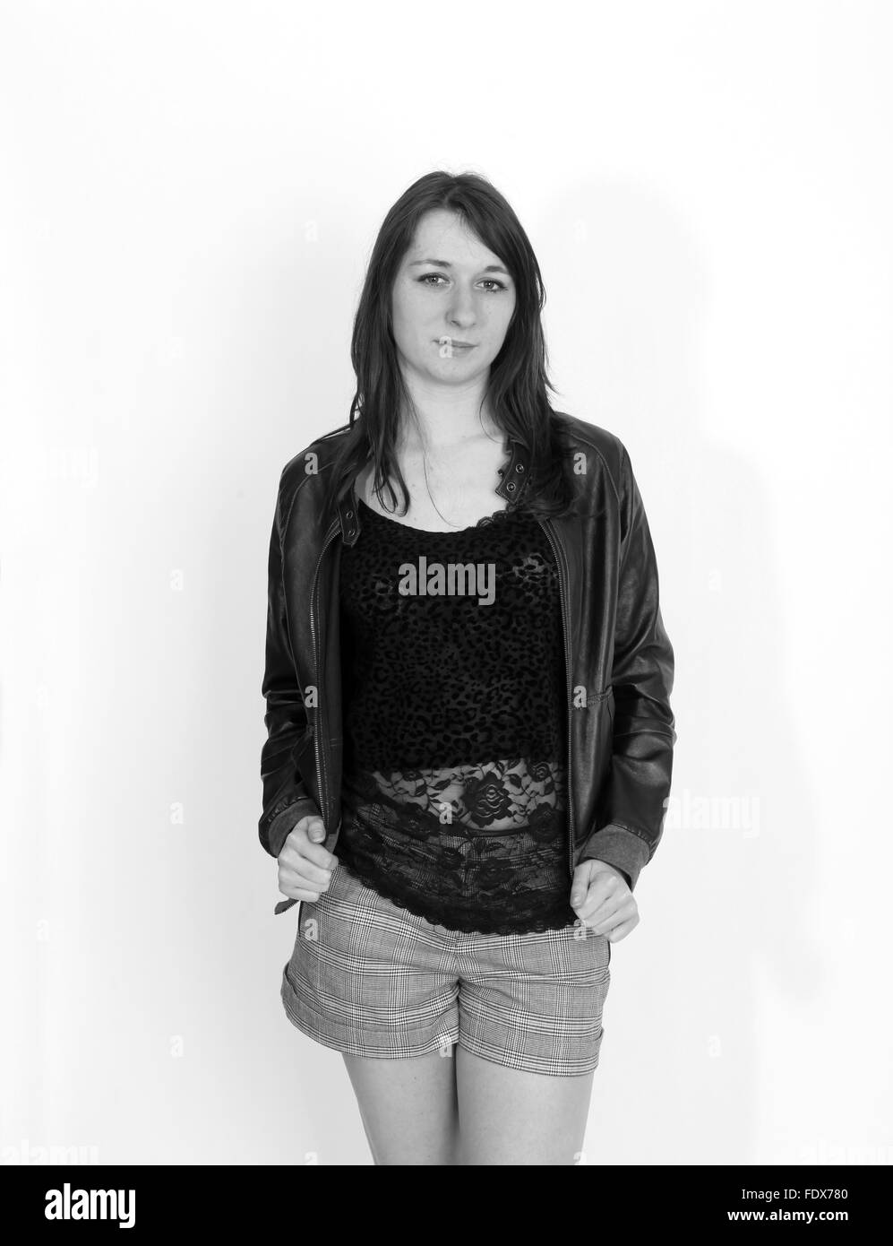 Beautiful young woman in a leather jacket and shorts Stock Photo - Alamy