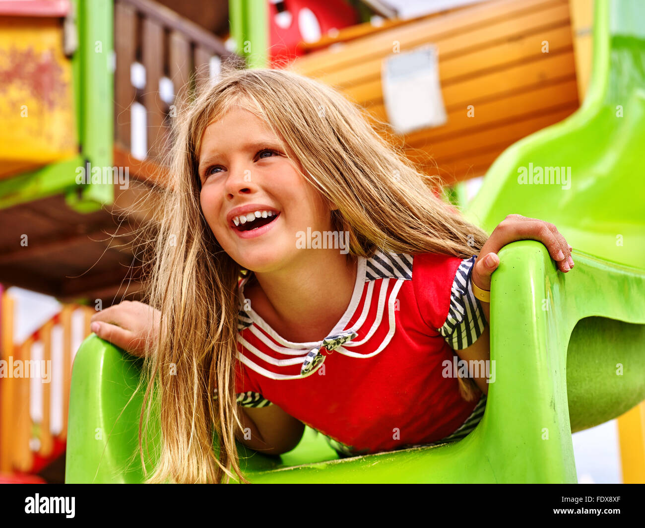 Child girl upside down on playground Stock Photo - Alamy