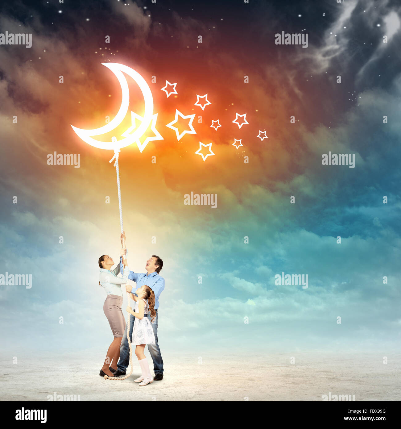 Image of young happy family pulling rope with a moon Stock Photo - Alamy
