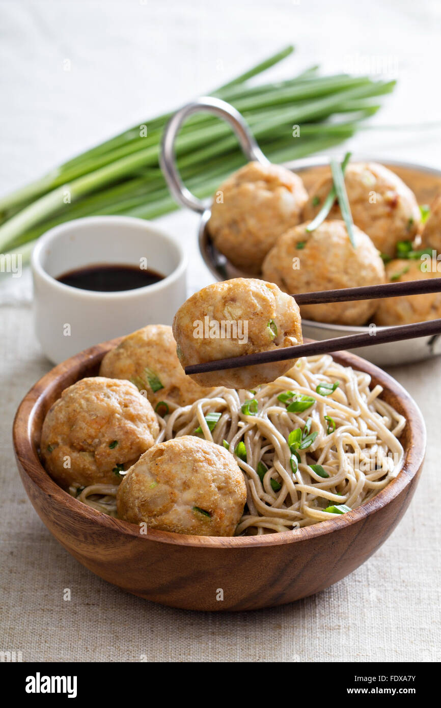 Soba noodles served with ginger chicken meatballs Stock Photo Alamy