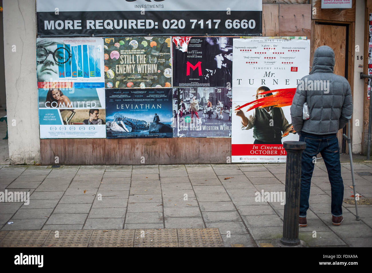 Watching movie posters, Crouch End, North London Stock Photo