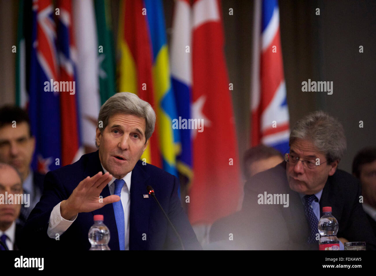 Rome, Italy. 2nd Feb, 2016. U.S. Secretary of State John Kerry (L) talks next to Italian Foreign Minister Paolo Gentiloni during a ministerial meeting regarding the action against Islamic State in Rome, Italy, Feb. 2, 2016. Key members of the global coalition against so-called Islamic State (IS), or Daesh, gathered in a meeting here on Tuesday, and pledged to step up military action against the group in Iraq and Syria. Credit:  Jin Yu/Xinhua/Alamy Live News Stock Photo