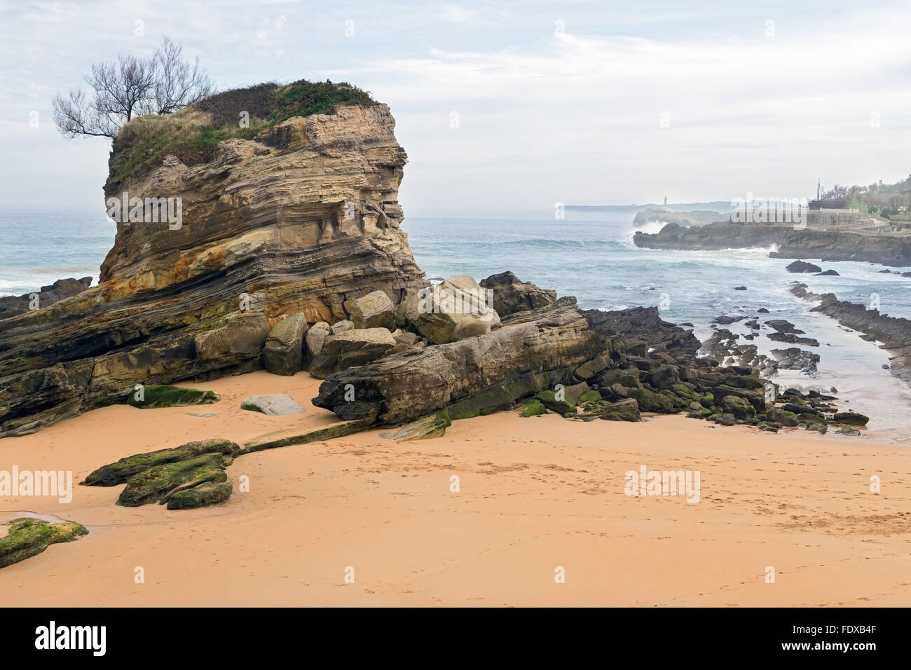 El Camello beach (Santander,Spain). In the background Mouro Island and lighthouse looks Stock Photo