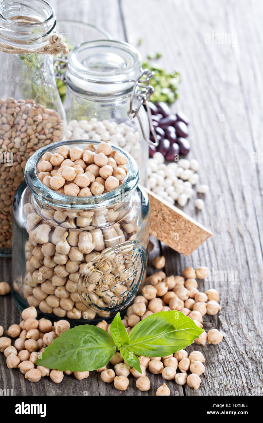 Raw beans and lentils in glass jars and bottles Stock Photo