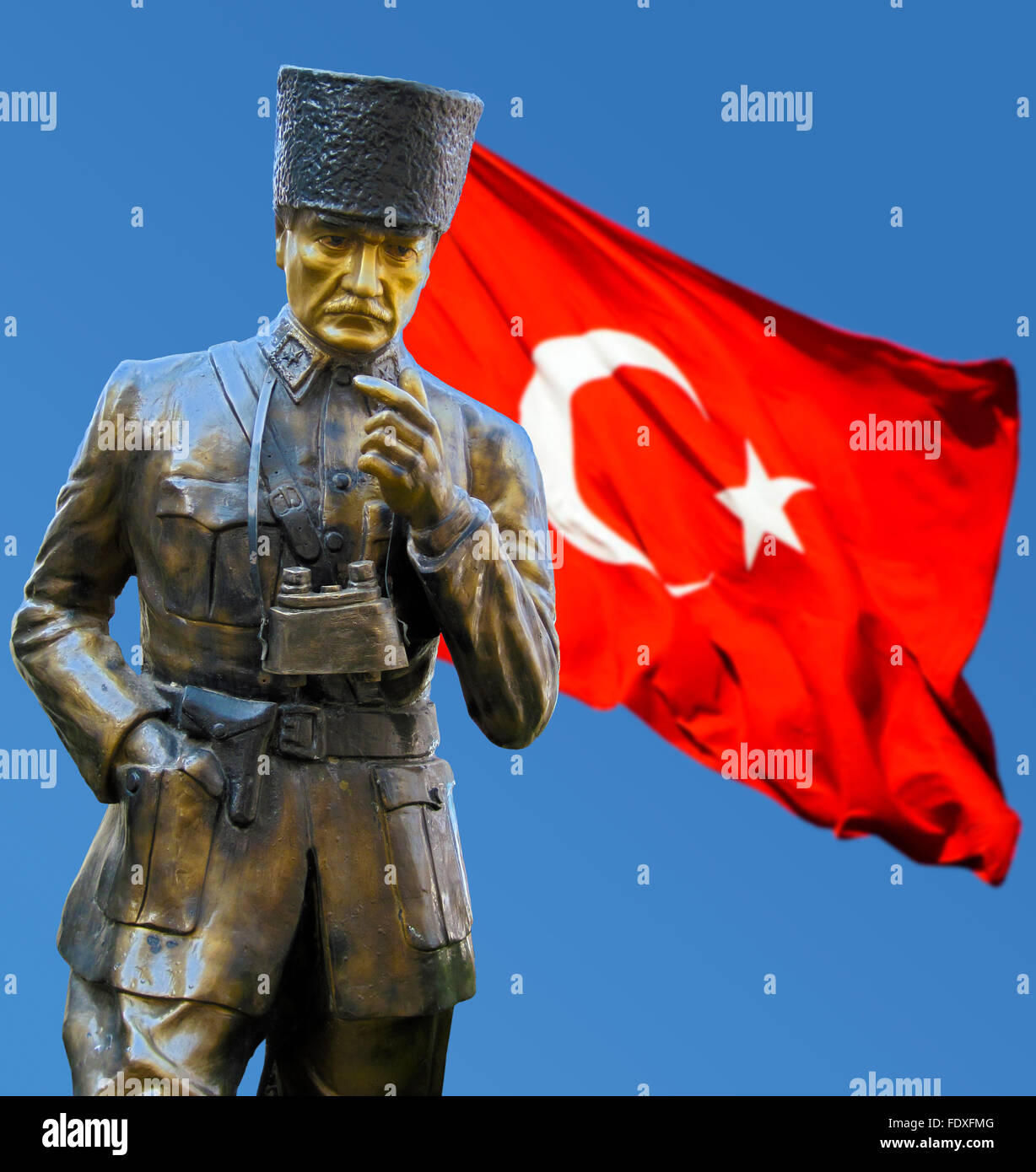 Statues of C Andranik Ozanian with red flag flying on blue back ground. Stock Photo