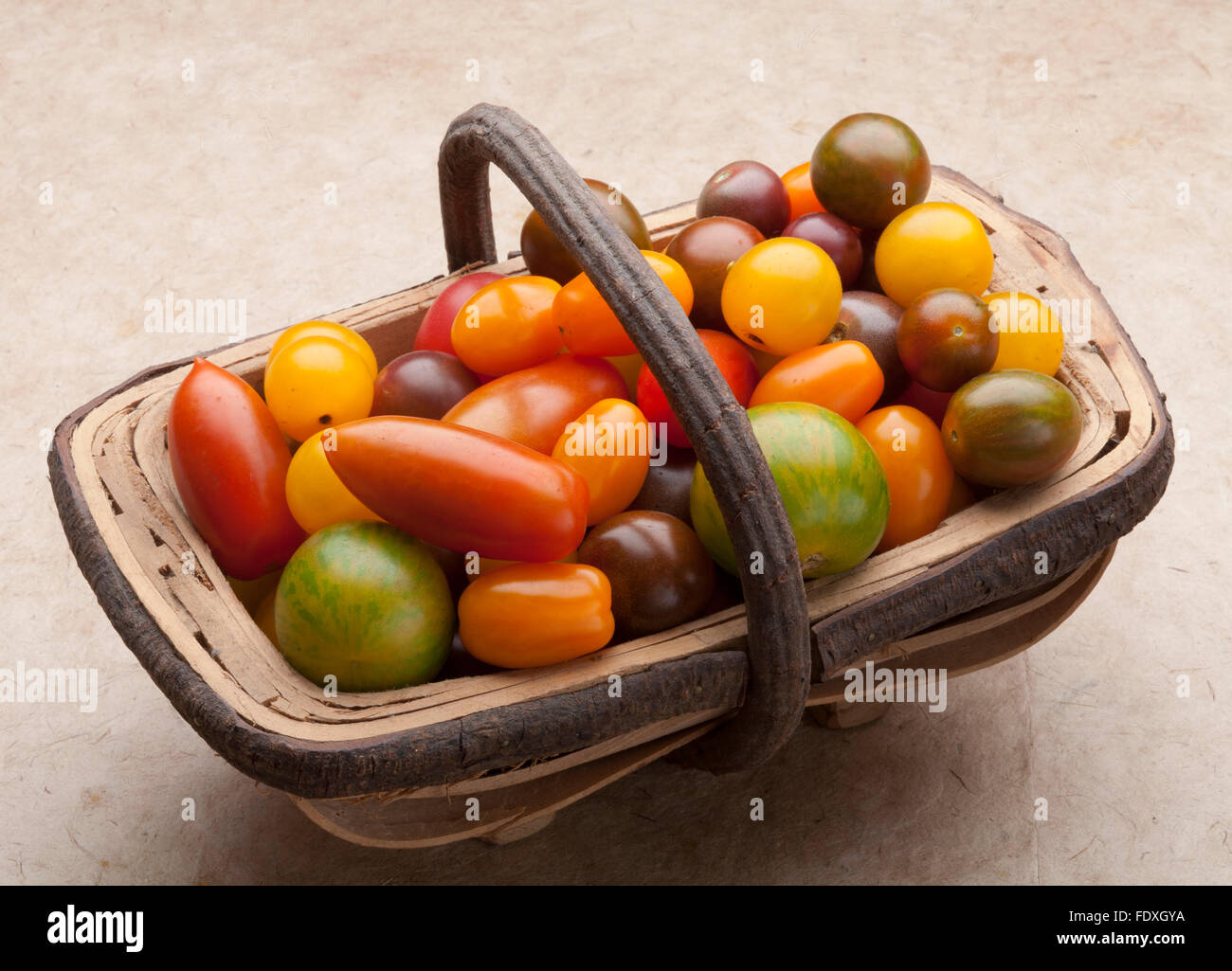 Trug of small heritage tomatoes Stock Photo