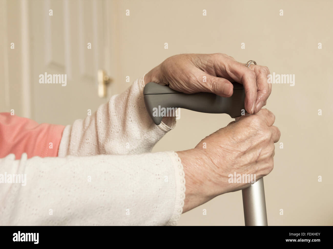 90 year old lady with hands on walking stick. UK Stock Photo