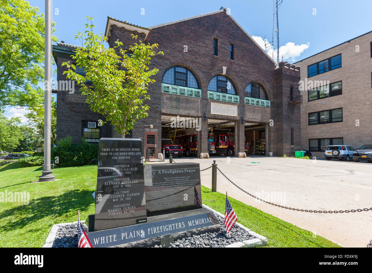 The White Plains Firefighters Memorial In front of Fire Department Headquarters and Fire Station No. 6 in White Plains, New York. Stock Photo