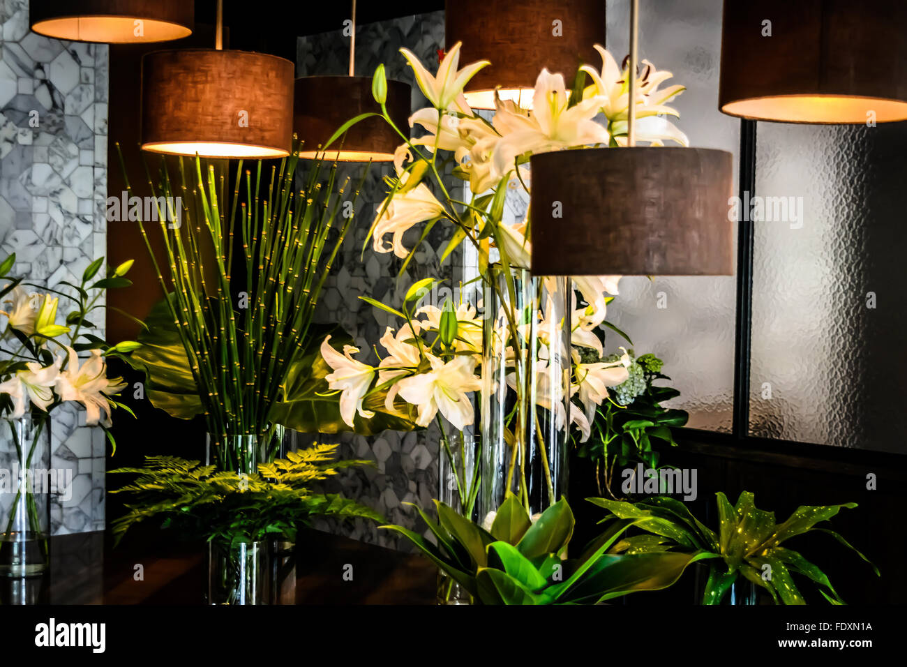 Hanging lights and lilies flower arrangements Stock Photo Alamy