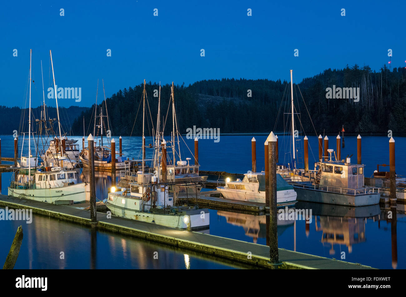 Fishing boats at docks on the Siuslaw River in Old Town Florence on the central Oregon coast. Stock Photo