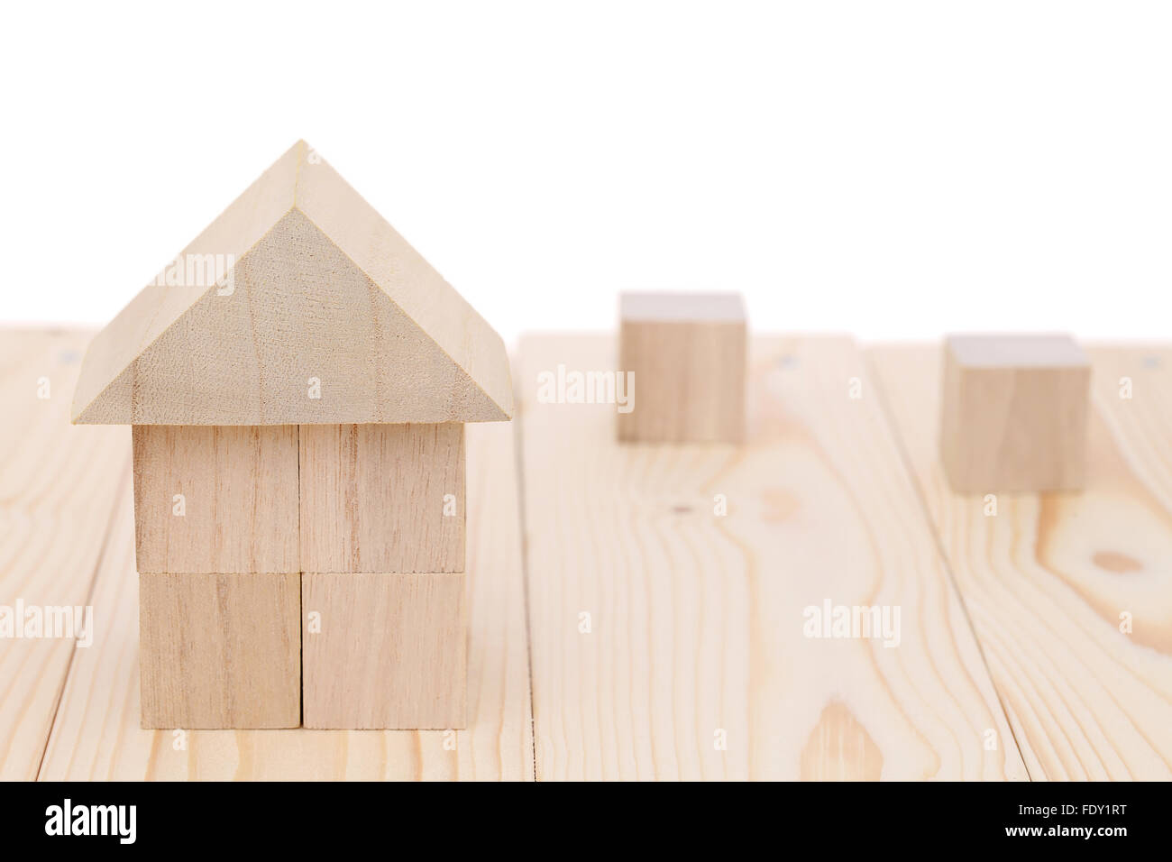 Wooden toy house with natural colored toy blocks Stock Photo