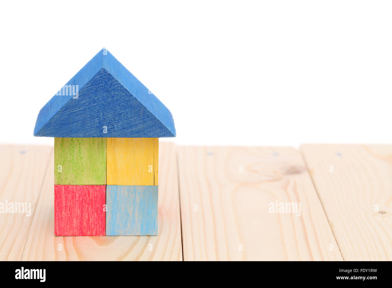 wooden toy house with colored toy blocks Stock Photo