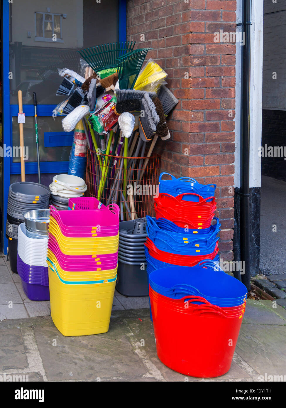 Display of plastic bucket containers and brooms and mops for cleaning  outside a small hardware shop Stock Photo - Alamy