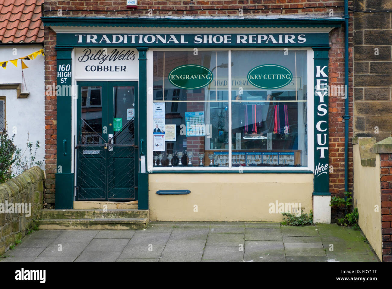 An old fashioned Cobbler's Shoe Repair shop in a village High Street Stock Photo