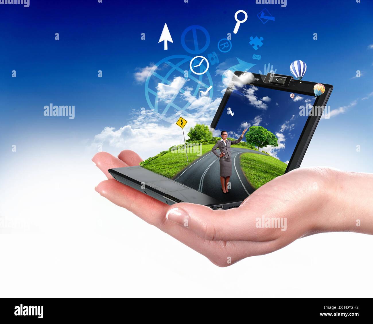 Collage with a human hand holding a green landscape Stock Photo - Alamy