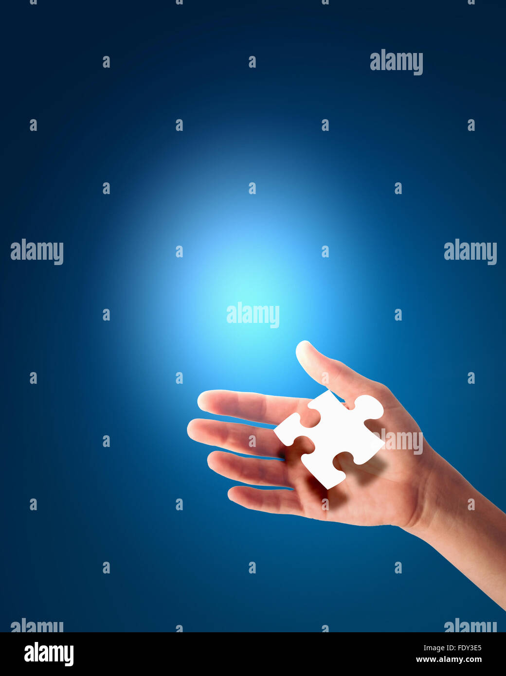 human hand with a blue shining piece of puzzle Stock Photo - Alamy