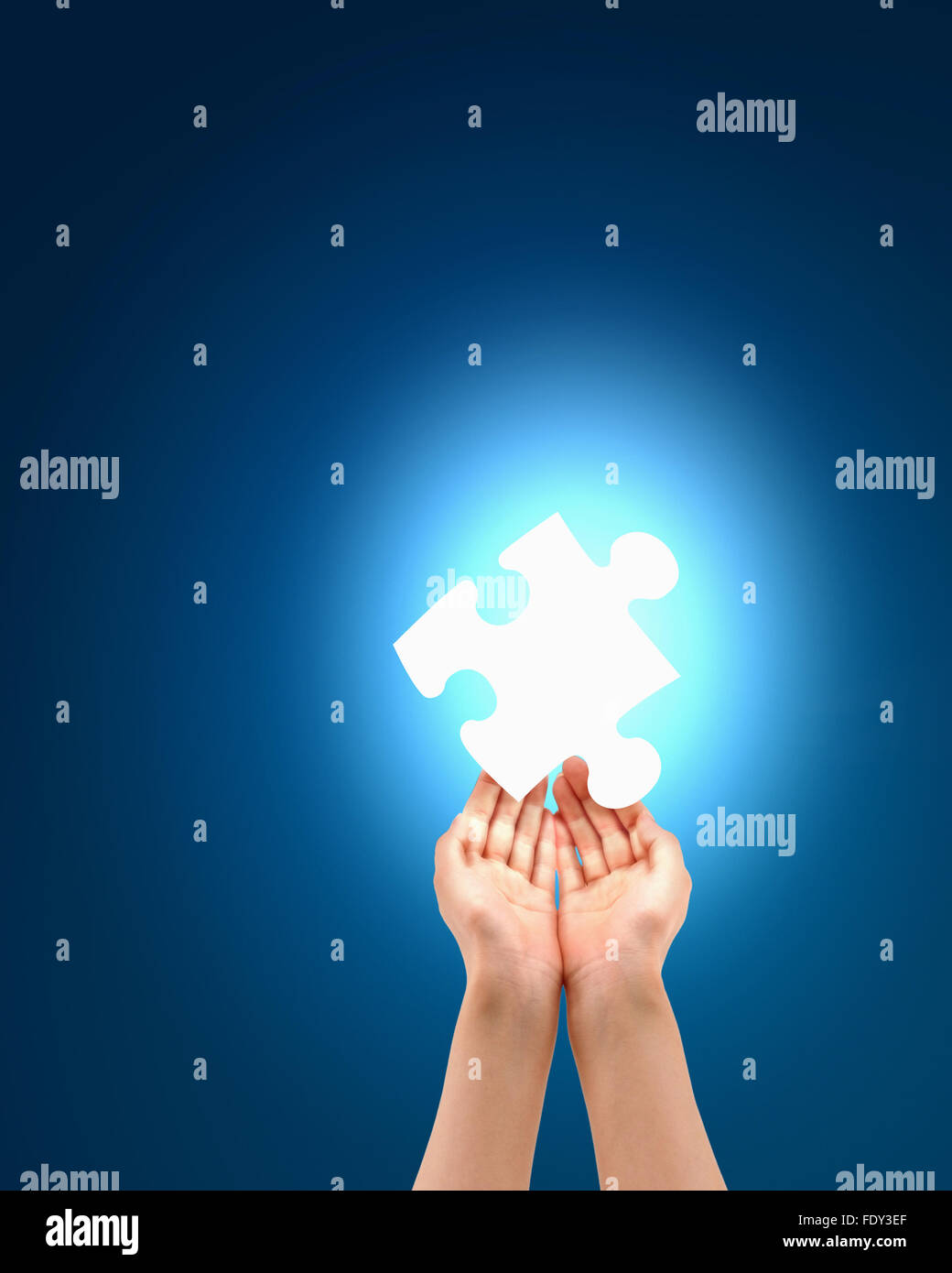 human hand with a blue shining piece of puzzle Stock Photo - Alamy