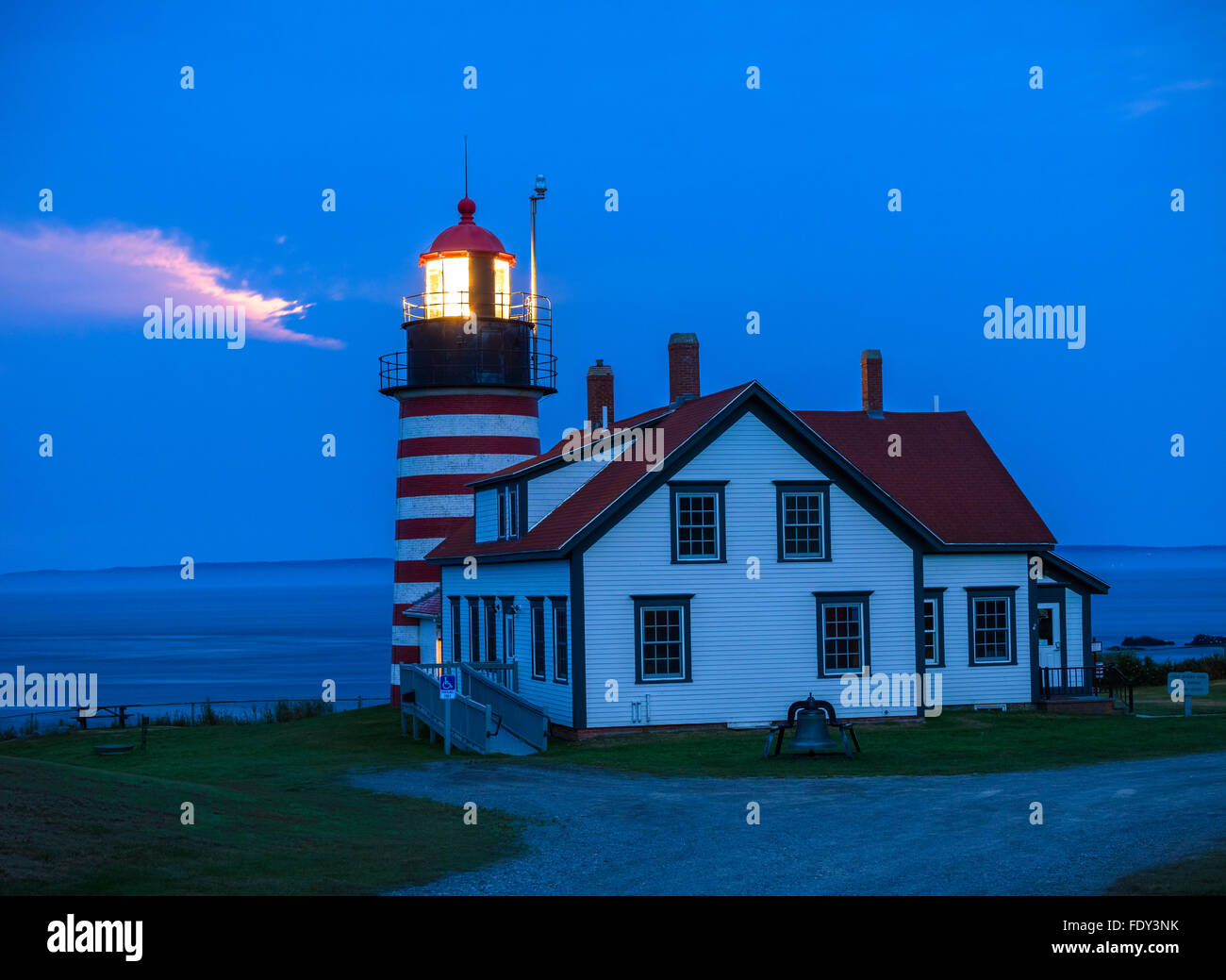 Lubec, Maine West Quoddy Head Light in evening with light from the
