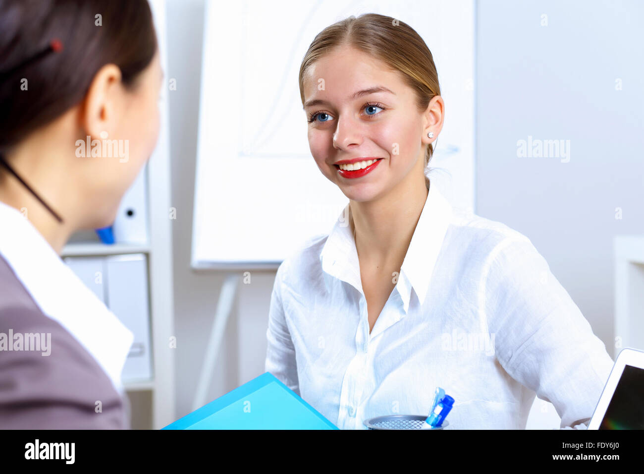 Young women in business wear working in office together Stock Photo - Alamy