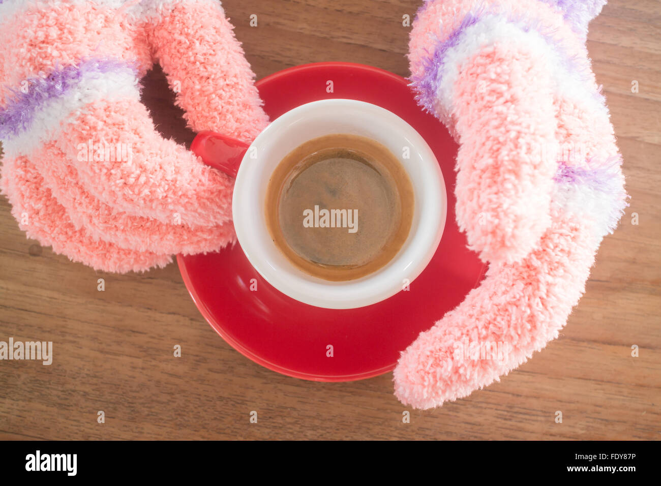 Gloved hands holding cup of coffee, stock photo Stock Photo - Alamy