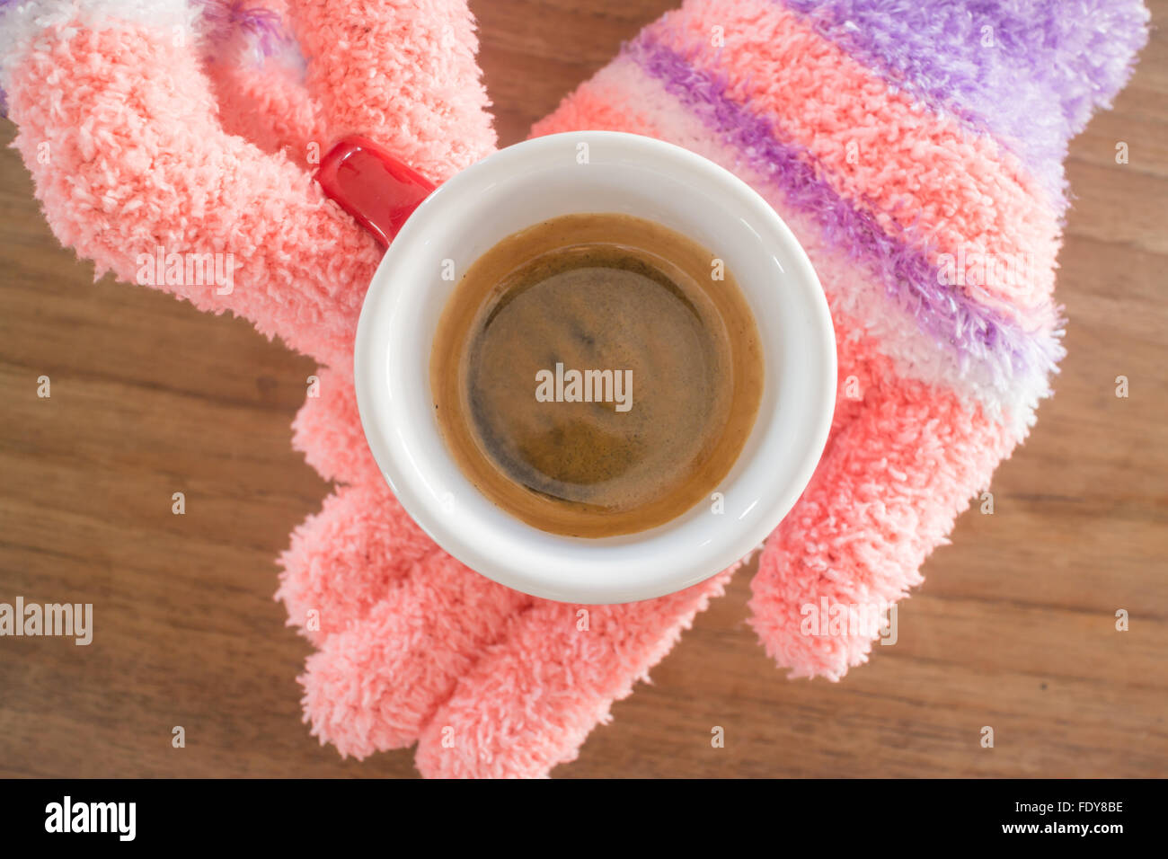 Gloved hands holding cup of coffee, stock photo Stock Photo - Alamy