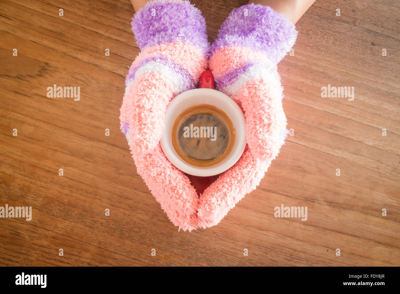 Gloved hands holding cup of coffee, stock photo Stock Photo - Alamy
