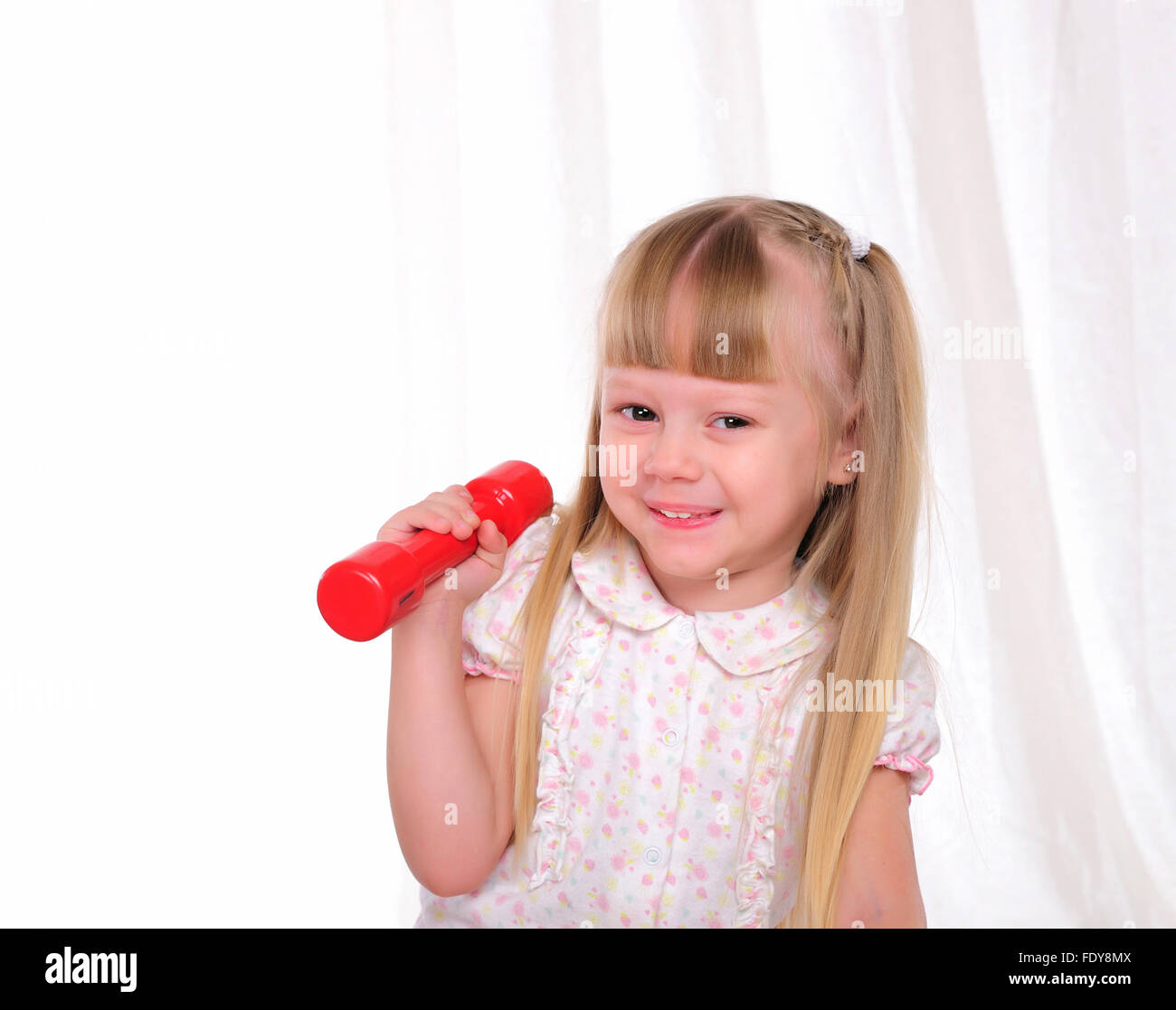 The little girl does exercises with dumbbells Stock Photo - Alamy