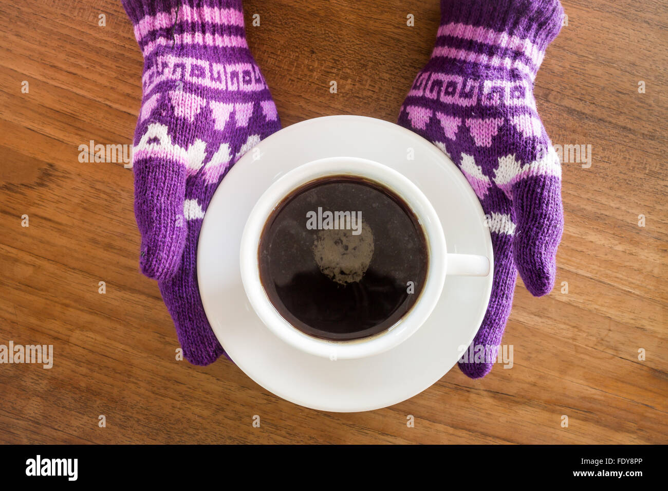 Gloved hands holding cup of coffee, stock photo Stock Photo - Alamy